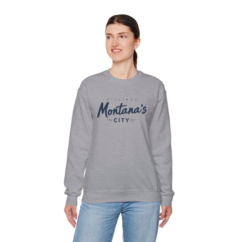 Person wearing gray Montana's City sweatshirt smiling.